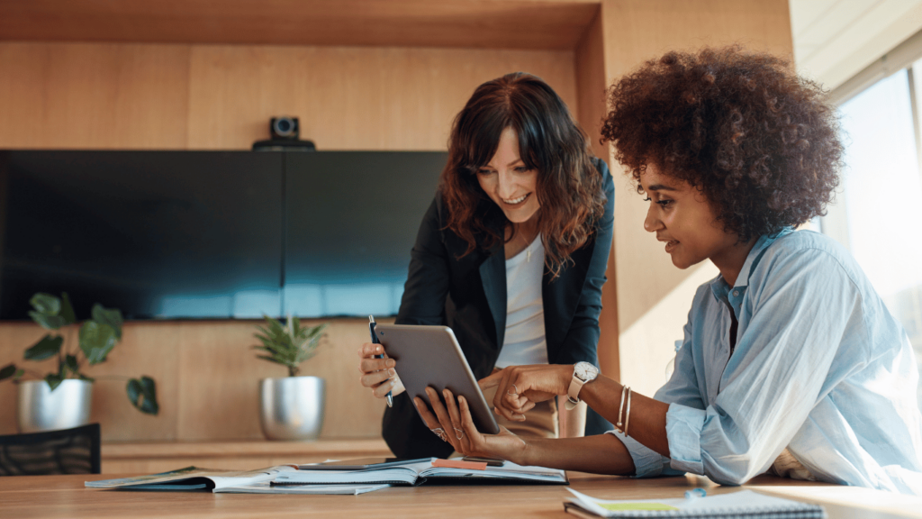 This image shows two women working together. Edgility's Talent Acquisition Services are a budget friendly option for organizations looking for Executive Search.