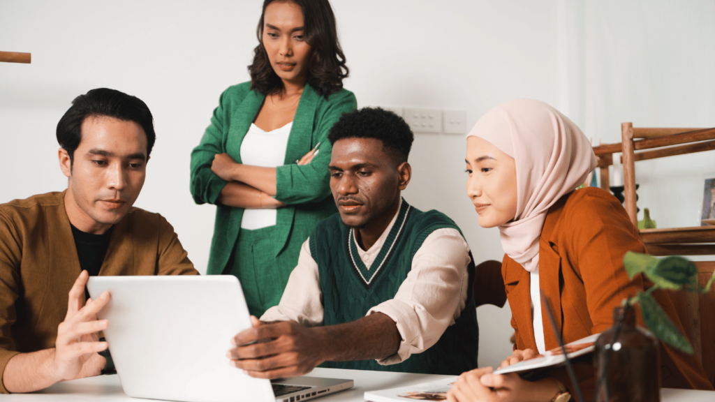 This image shows a group of coworkers deliberating in front of a laptop. Edgility helps you keep your salary structures transparent and compliant.